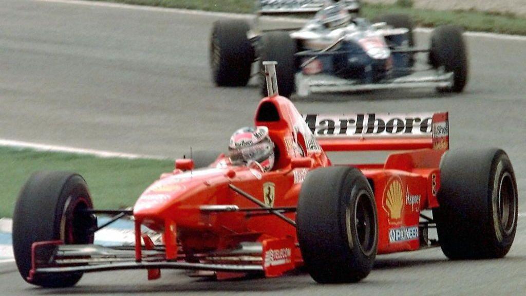 Ferrari's Michael Schumacher driving ahead of Williams' Jacques Villeneuve before the German driver crashed out of the race