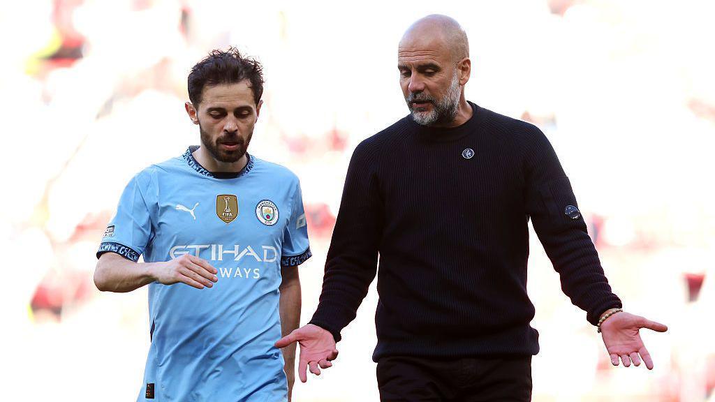 Pep Guardiola interacts with Bernardo Silva