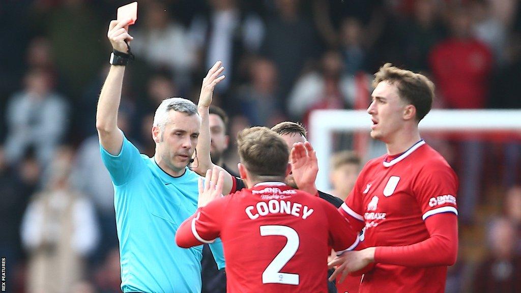 Ryan Cooney is shown a red card