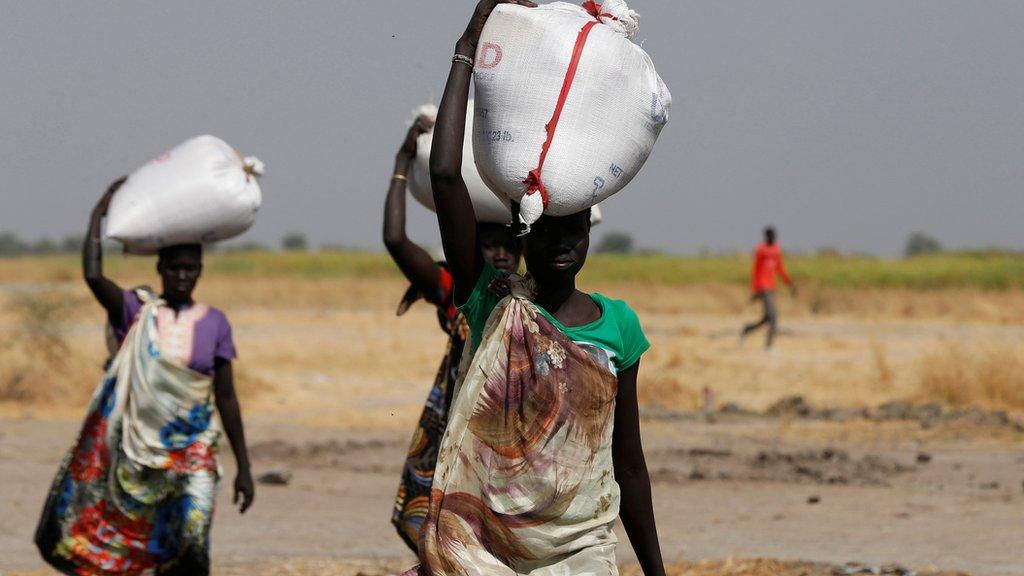 Women carrying sacks of food in South Sudan