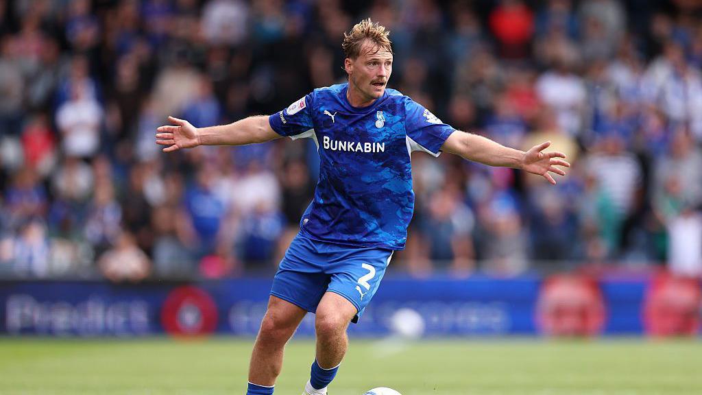 Gus Scott-Morriss of Oldham Athletic runs with the ball during a League Two match with Port Vale at Boundary Park