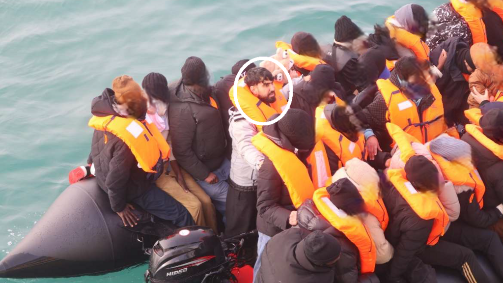 Mohammad Tajik on board a boat packed with people wearing life jackets in the English Channel.
