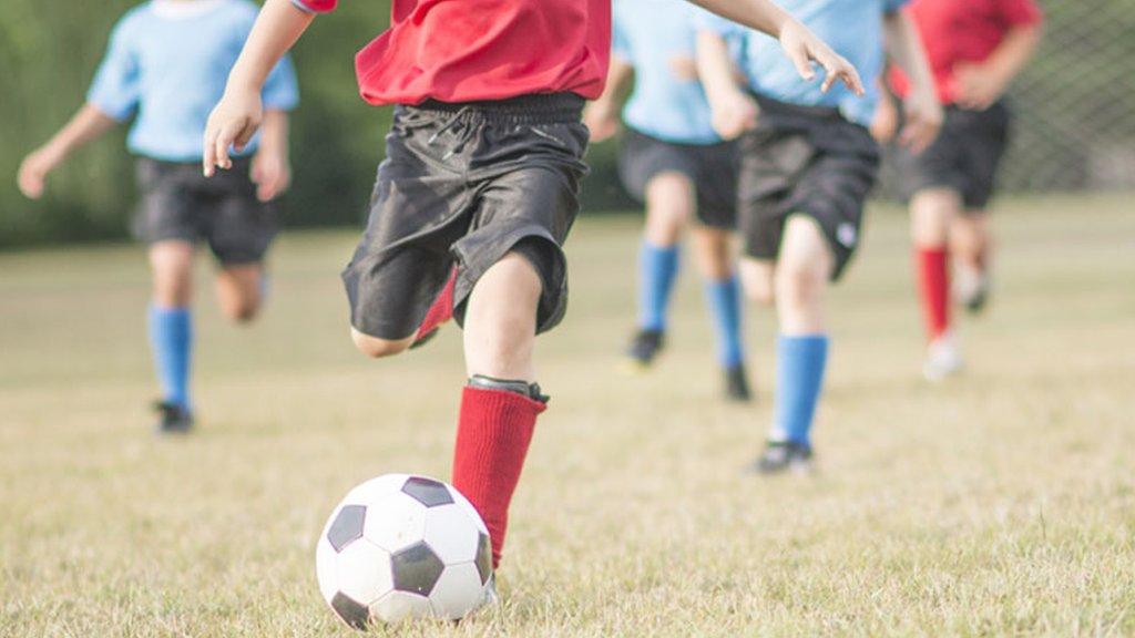 children playing football