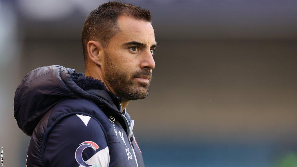 Reading boss Ruben Selles wearing a puffer coat watches his side take-on Millwall in the first round of the EFL Cup