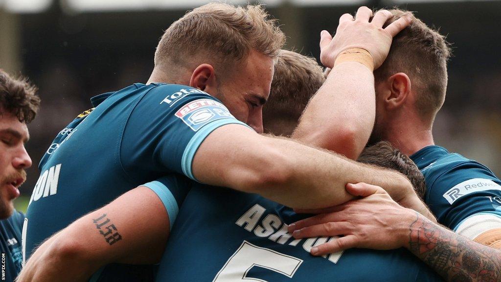 Warrington players celebrate a try for Matty Ashton