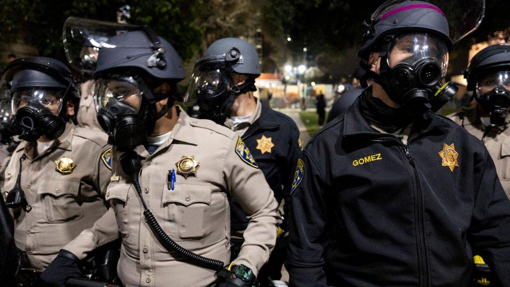 Police officers stand in a line at UCLA