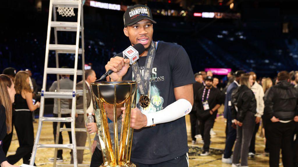 Giannis Antetokounmpo holding the NBA Cup trophy
