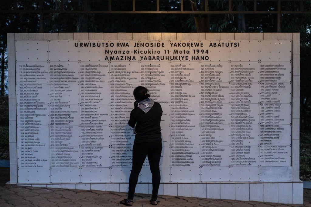 A woman stands in front of list of names of people killed during the 1994 Genocide against the Tutust at Nyanza Genocide Memorial Centre in Kigali in April 2024. 