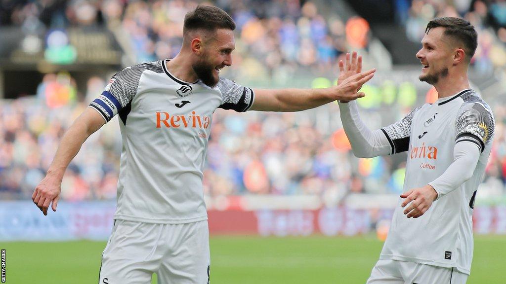 Matt Grimes celebrates with Liam Cullen