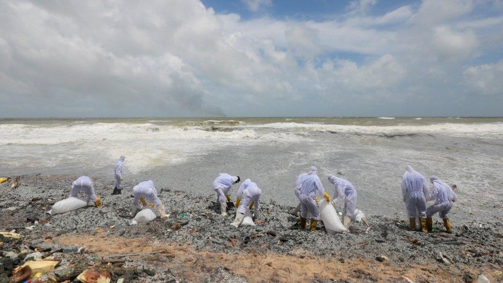 Sri Lankan navy members remove debris washed off to a beach from the MV X-Press Pearl container ship which caught fire off the Colombo Harbour, on a beach in Ja-Ela, Sri Lanka 27 May 2021.