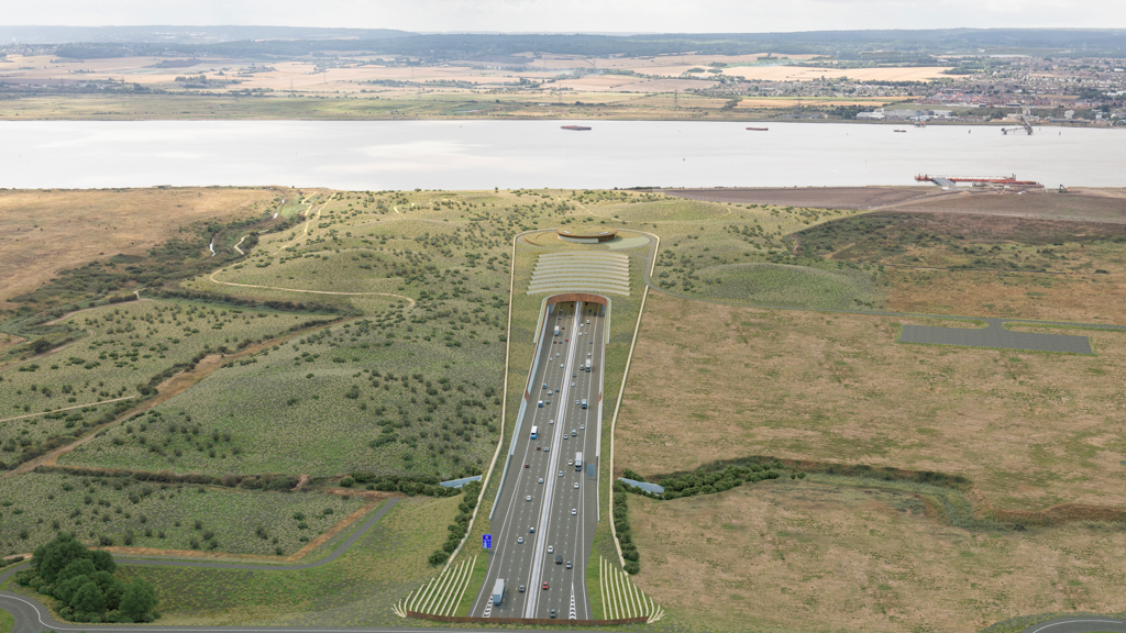 A graphic of the Lower Thames Crossing, which shows multiple lanes of traffic in both directions going into a tunnel beneath the River Thames. The road is surrounded by fields either side of the water.