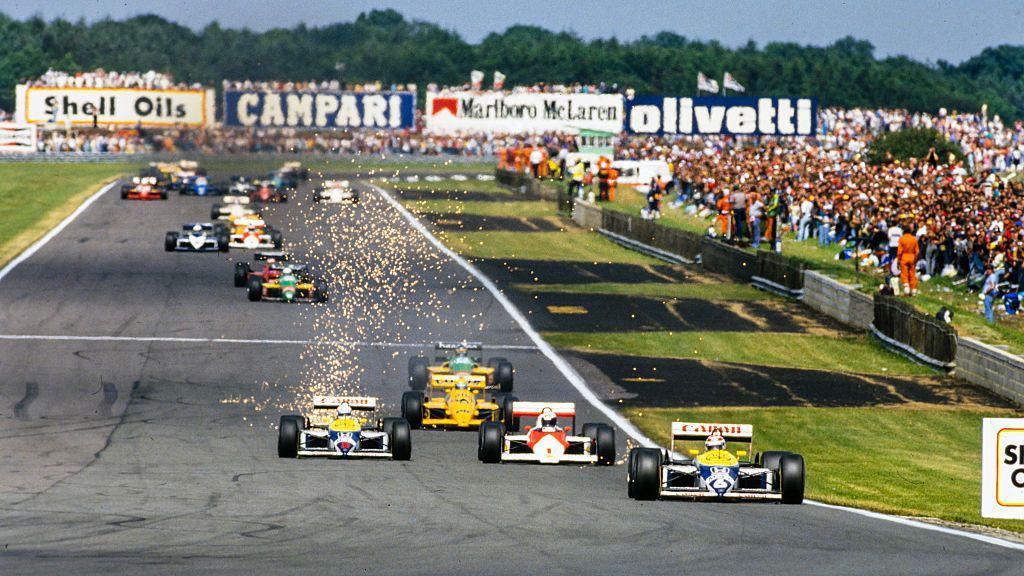 Nigel Mansell's Williams moves out to overtake McLaren's Alain Prost for second place in the early stages of the 1987 race at Silverstone. Nelson Piquet leads but, after a pit stop to change tyres, Mansell would hunt him down and overtake the Brazilian with three laps to go for a thrilling victory