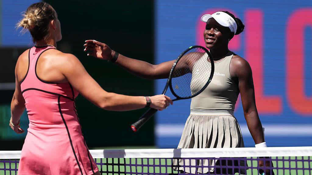 Aryna Sabalenka embraces Victoria Mboko at the net