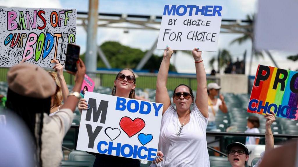 Abortion rights supporters rally in Miami, Florida in September in support of Amendment 4. They hold signs that read "My Body, My Choice" and "Mother For Choice, By Choice."