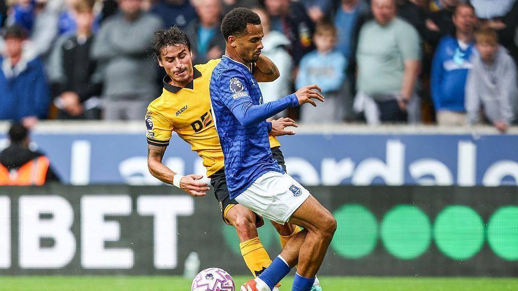 Iliman Ndiaye challenges Hugo Bueno during Everton's victory over Wolves at Molineux