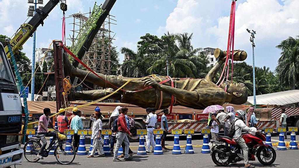 Lionel Messi's 70ft statue laid horizontally being transported.
