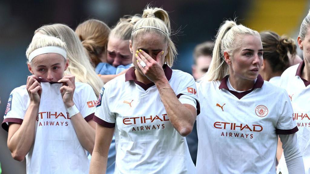 Steph Houghton of Manchester City cries alongside teammates Chloe Kelly and Alex Greenwood, after making her final appearance before retiring