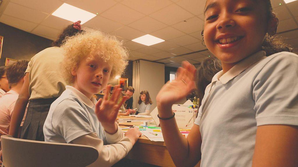 two-children-waving-at-the-camera