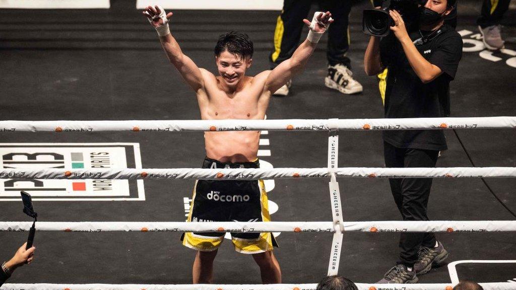 Naoya Inoue holds his hands up in celebration