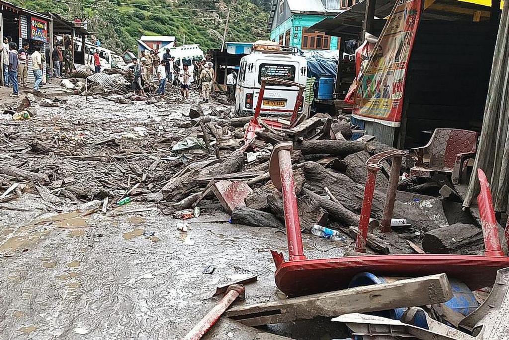 Rescuers are seen inspect the site of a flashflood at a village in Kishtwar district on August 14, 2025. 