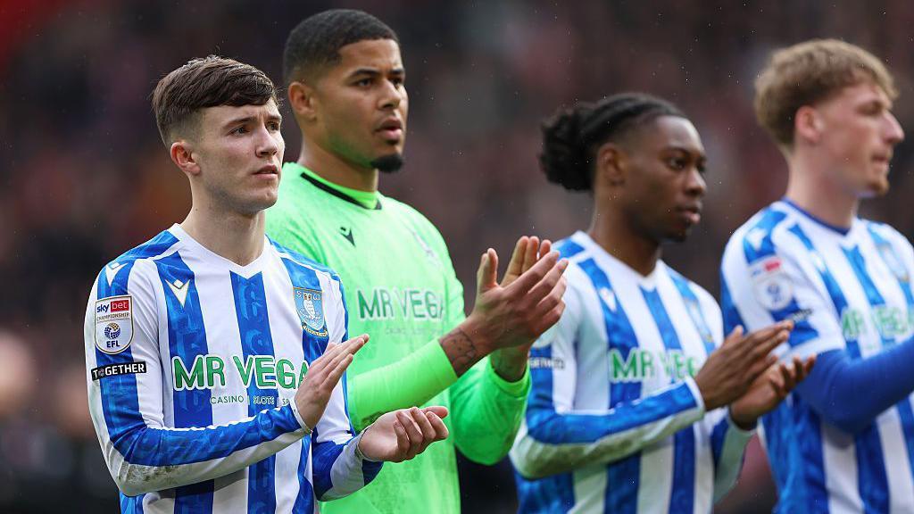Sheffield Wednesday players applaud their fans after their relegation to League One was confirmed in February