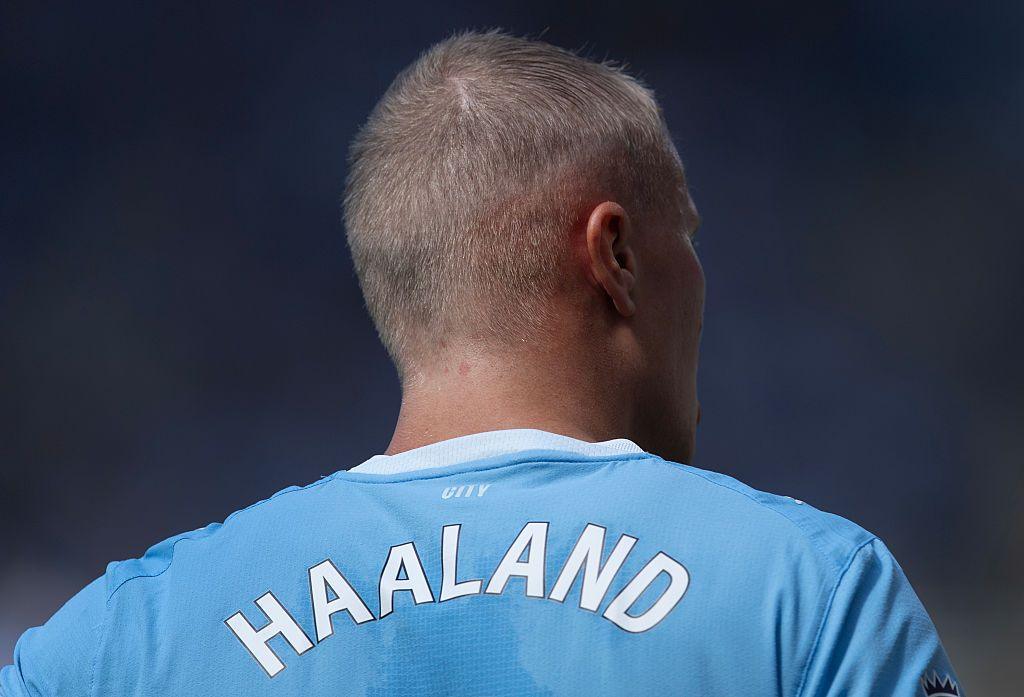 A shot of Haaland from behind, showing of his new buzz-cut and the back of his Man City shirt displaying his name. 