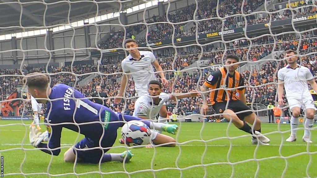 Swansea defender Ben Cabango looks back in despair after turning Harry Vaughan's cross into his own net as he attempted to clear