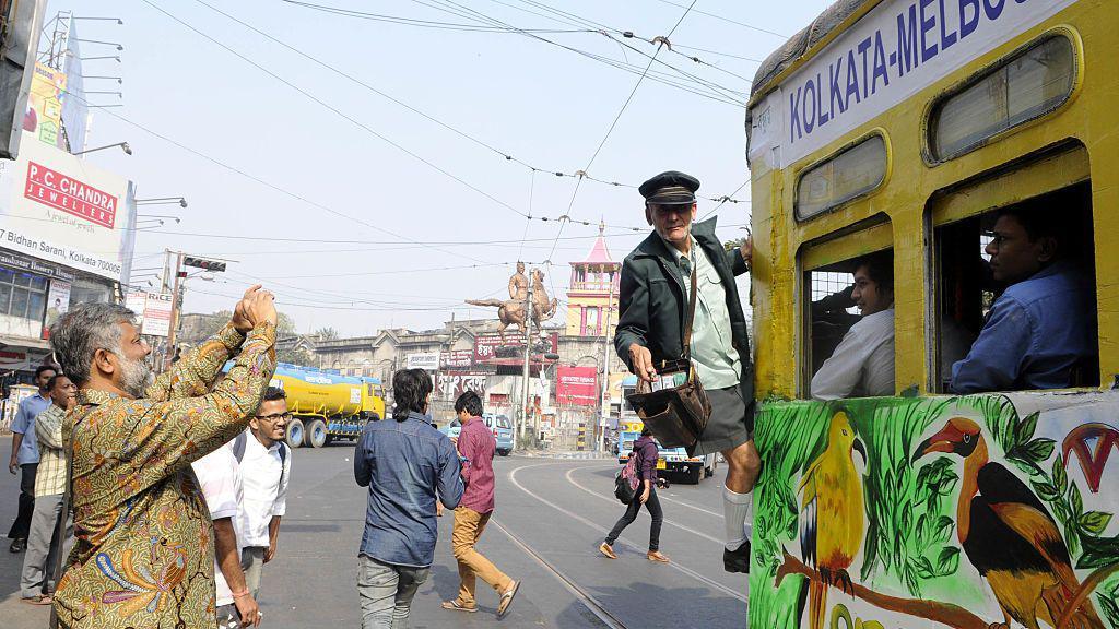 oberto D'Andrea, tram conductor of Melbourne, enjoying the joyride in a newly decorated tram to celebrate the 20th anniversary (1996 - 2016) of Kolkata Melbourne Tramjatra approaching Esplanade, on December 10, 2016 in Kolkata, Indi