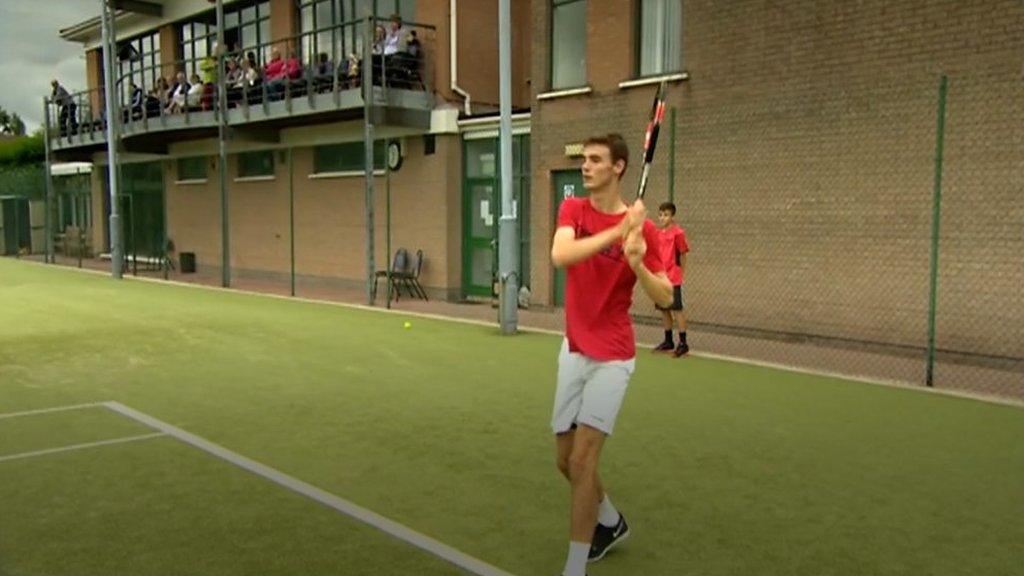 A boy playing tennis