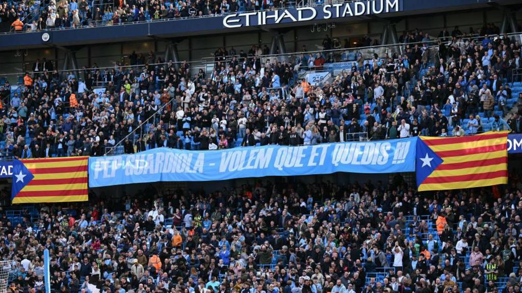 A banner that reads "Pep Guardiola, we want you to stay" in his native Catalan language is displayed at Etihad Stadium during Manchester City's 3-2 home win over Fulham.