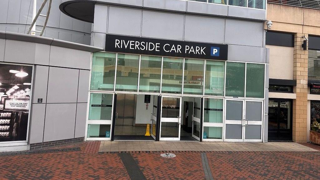 Grey building with a sign saying Riverside Car Park
