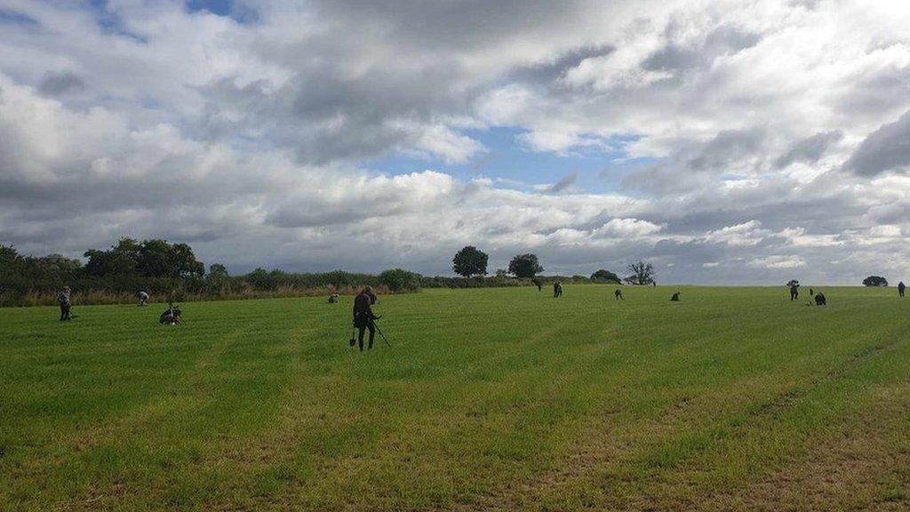 Detectorists in a field