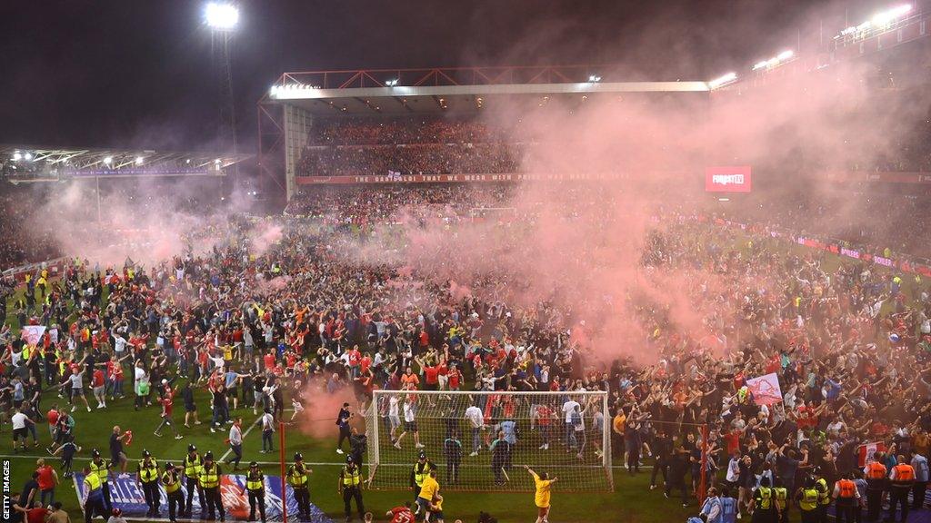 Fans coming on to Nottingham Forest's pitch following their win against Sheffield United in the Championship play-offs in May 2022