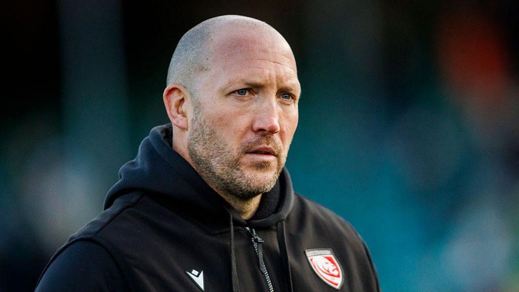 George Skivington standing on the pitch before kick-off in a match