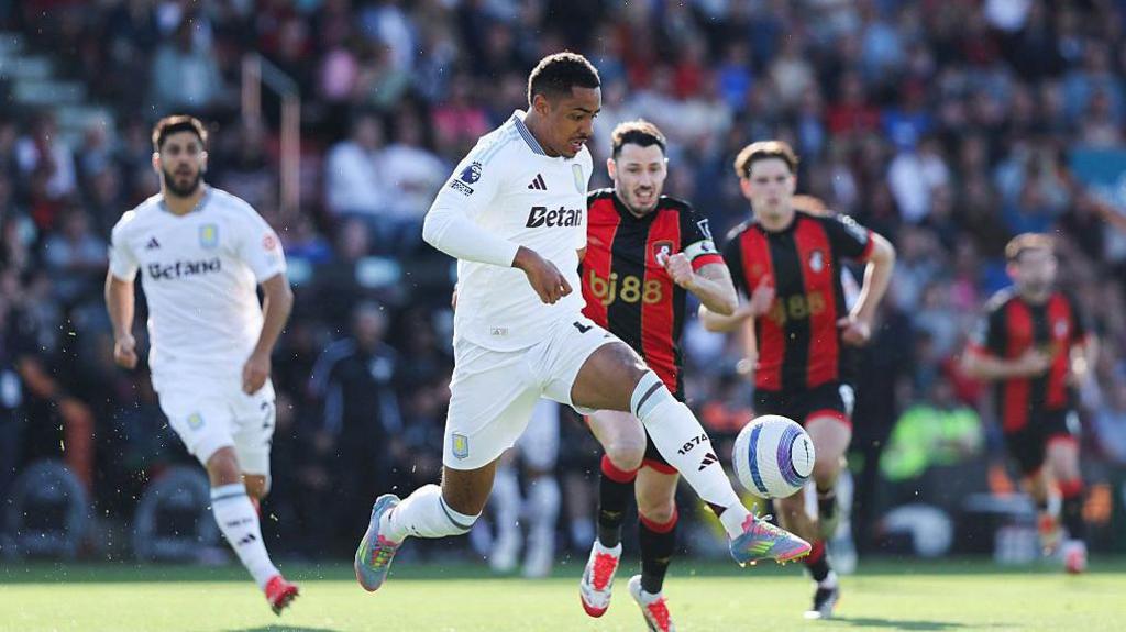 Aston Villa midfielder Jacob Ramsey controls the ball while chased by Bournemouth defender Adam Smith during the Premier League match at Vitality Stadium.