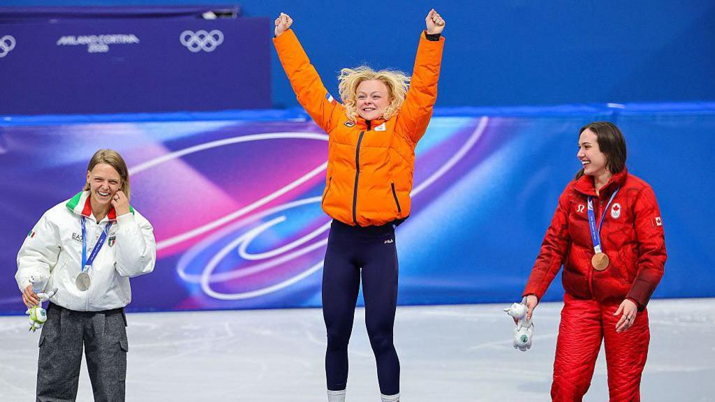 Gold medalist Xandra Velzeboer of Team Netherlands, silver medalist Arianna Fontana of Team Italy and bronze medalist Courtney Sarault of Team Canada celebrate on the podium during the medal ceremony for the Short Track Speed Skating Women's 500m
