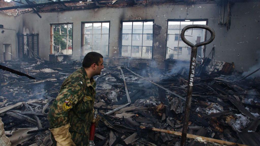 A fireman investigates a gym during the rescue operation at Beslan school