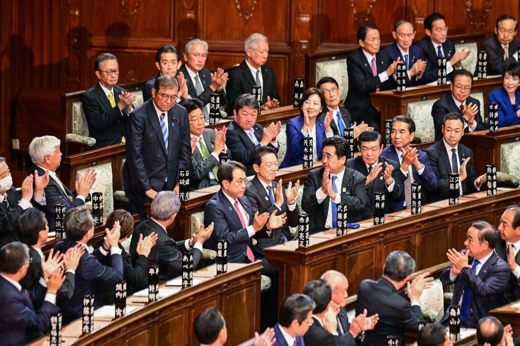 Lawmakers applaud in parliament as Japan's Prime Minister Shigeru Ishiba stands after being reappointed as leader after the second round of a parliamentary vote to nominate a prime minister.