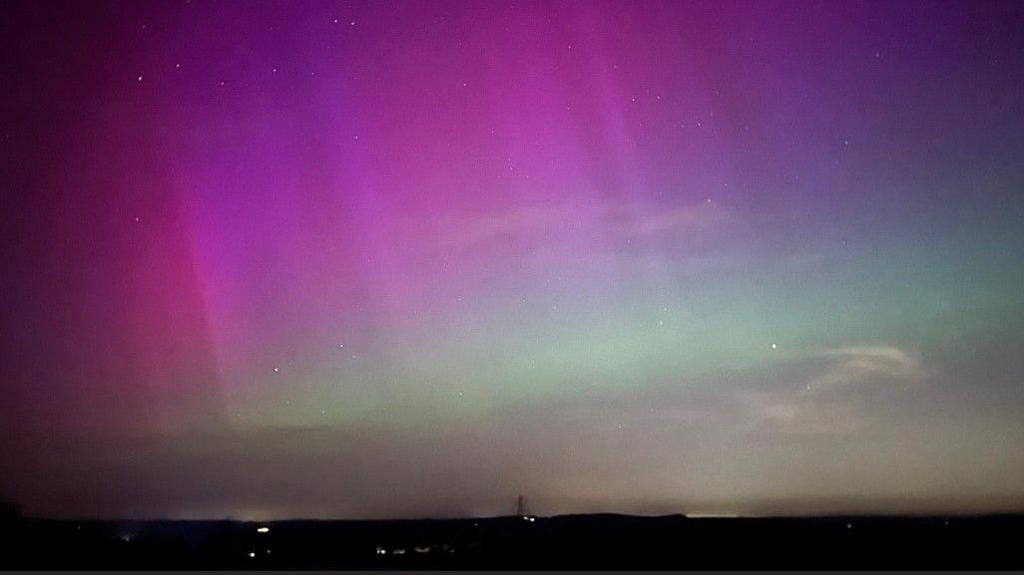 Hughes of purple and green lights over Malling Down