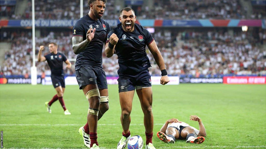 Joe Marchant celebrates his try with help from England captain Courtney Lawes