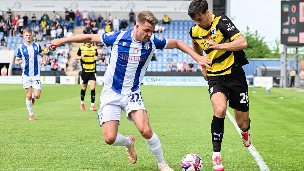 Jack Tucker playing for Colchester United against Barrow