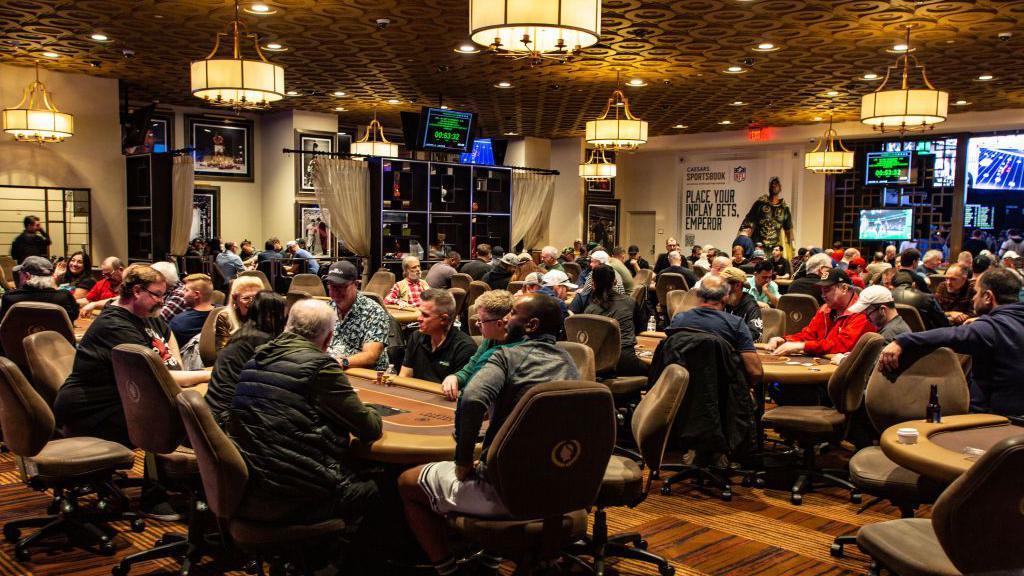 Dozens of poker players around tables at Caesars Palace