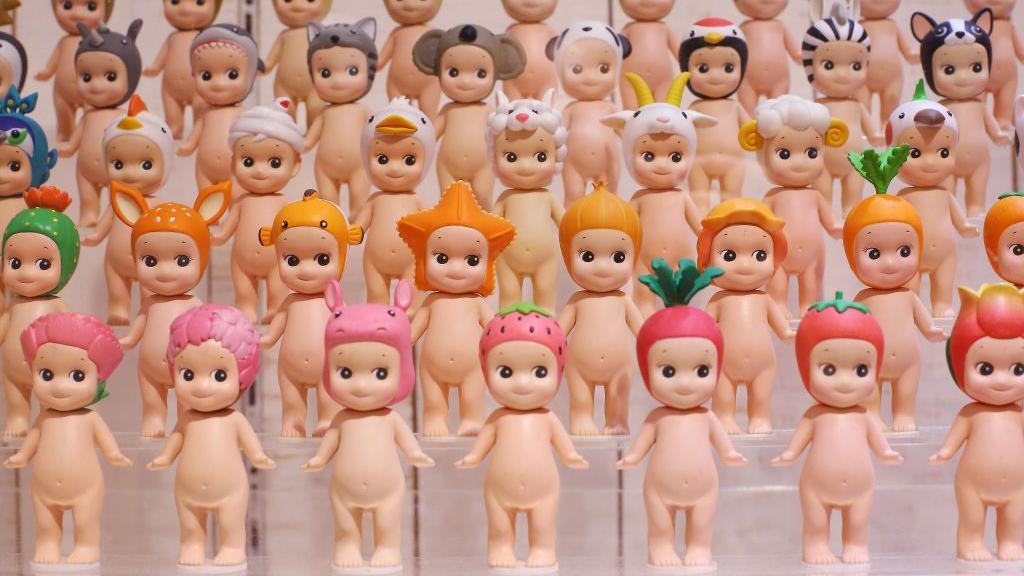 Five rows of Sonny Angel toys are pictured in a colour co-ordinated collection of the miniature baby dolls.