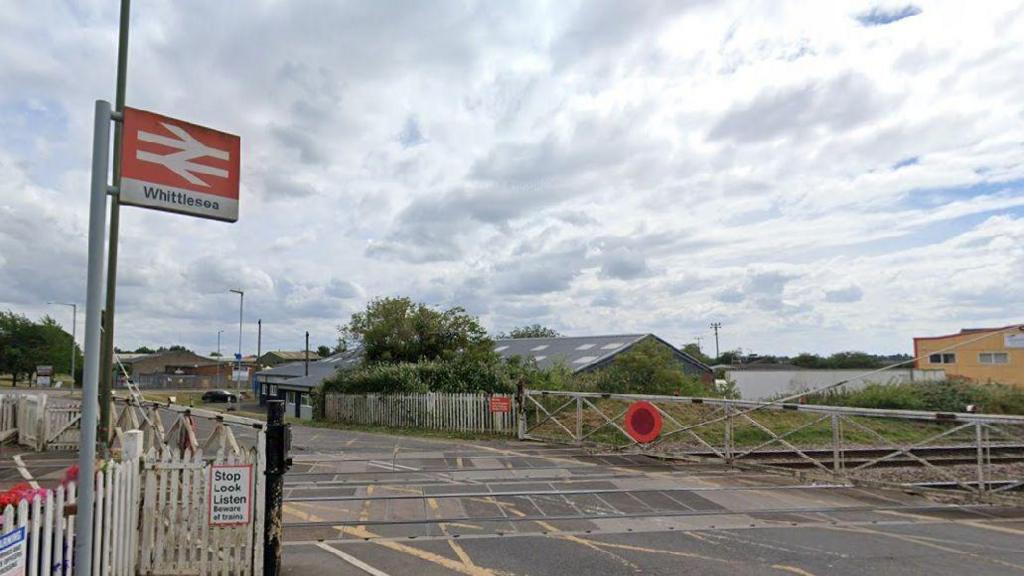 An exterior shot of the Whittlesea Station sign and level crossing