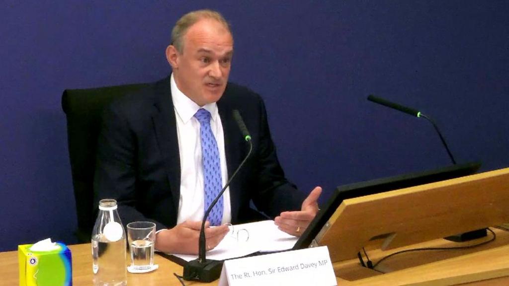 Ed Davey gives evidence at a desk at the Post Office inquiry