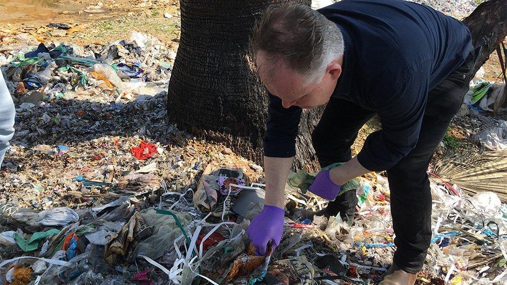 Angus looks through rubbish