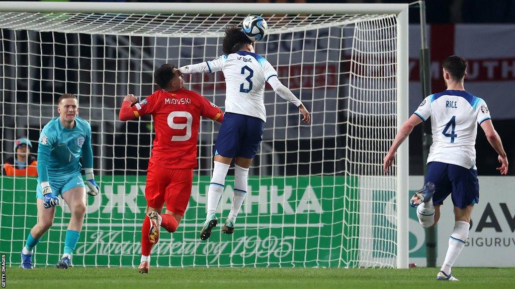 Rico Lewis catches North Macedonia forward in the penalty area