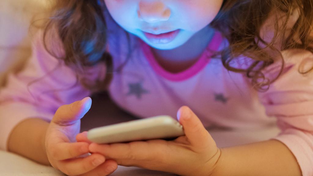 Anonymous child using a smartphone