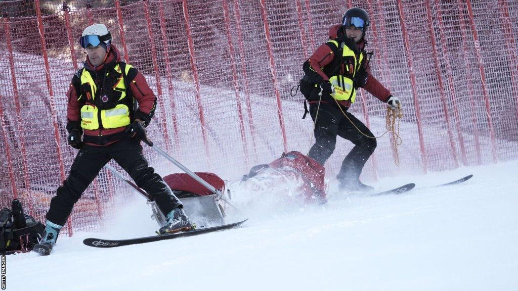 Petra Vlhova is removed from the course on a sled