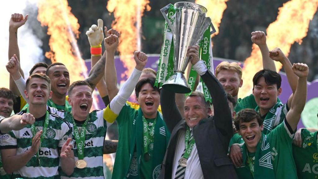 Celtic manager holding up Premiership cup